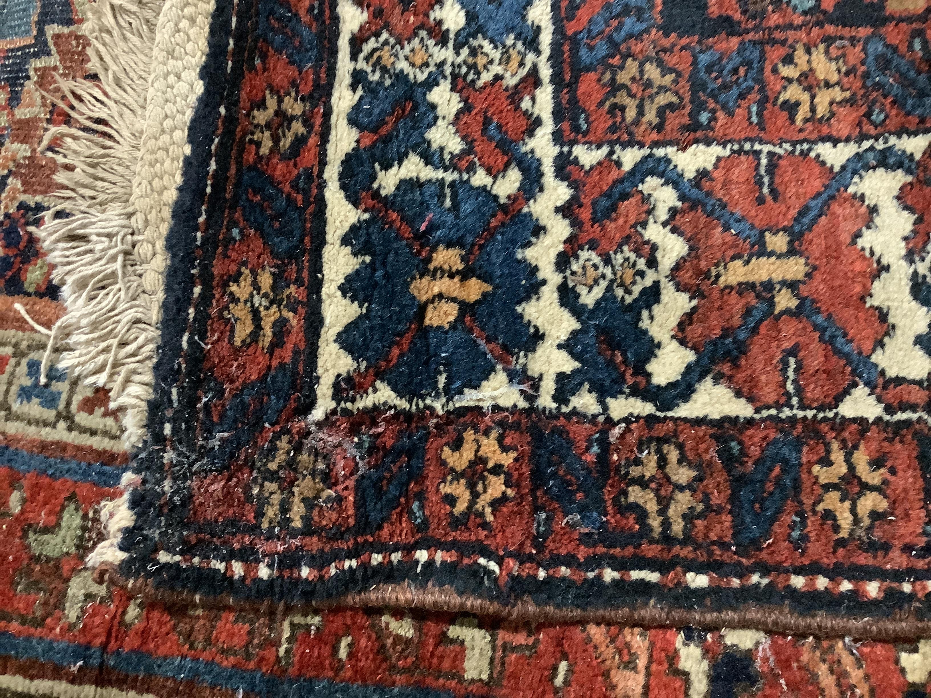 A Persian blue ground runner with field of stylised floral motifs, 428 x 83cm